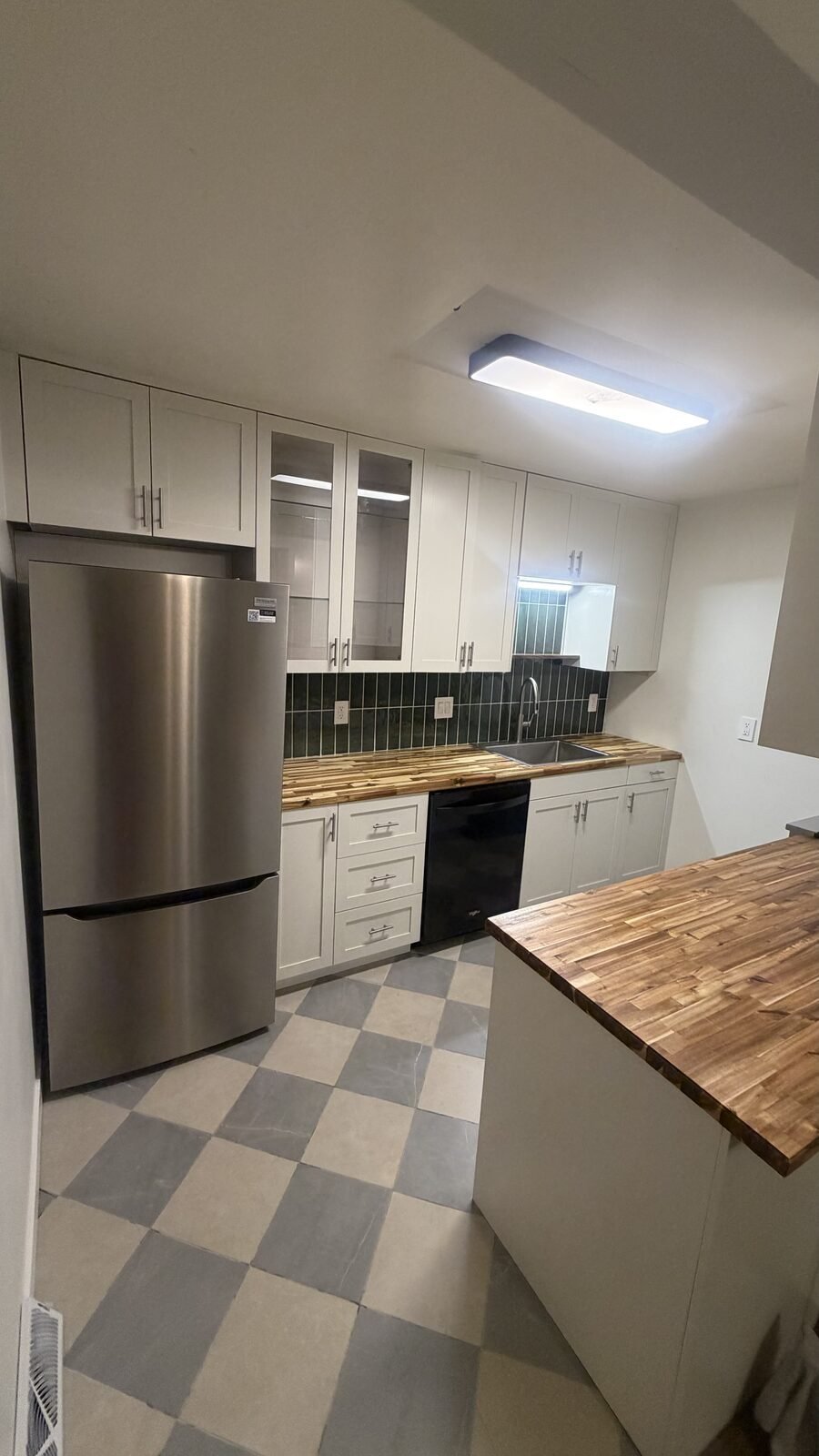 Madison WI kitchen remodel after — white shaker cabinets, butcher-block counters, green tile backsplash