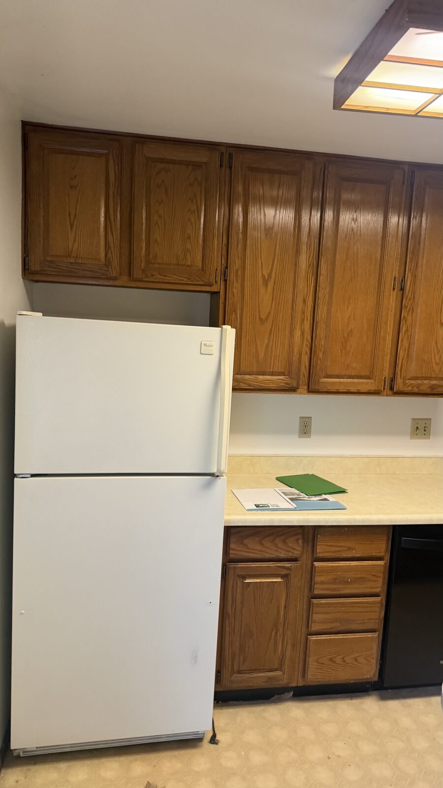 Madison WI kitchen before remodel — wood upper cabinets and white top-freezer refrigerator